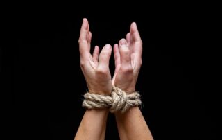 Hands tied with rope (photo)